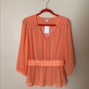 Peach peplum sheer top